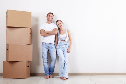 Van moving service with safety-focused team handling boxes and furniture carefully