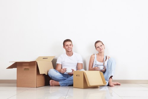 Packed boxes and furniture being moved from a flat in Mill Hill