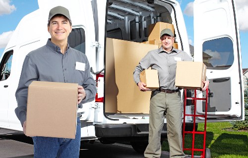 Loading household furniture into a van for a Mill Hill relocation